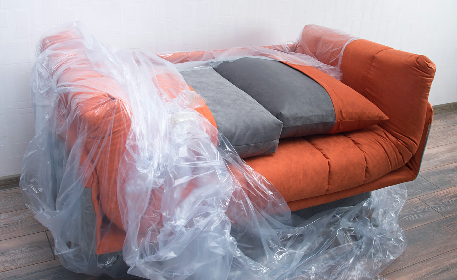 image of a couch covered in protective plastic